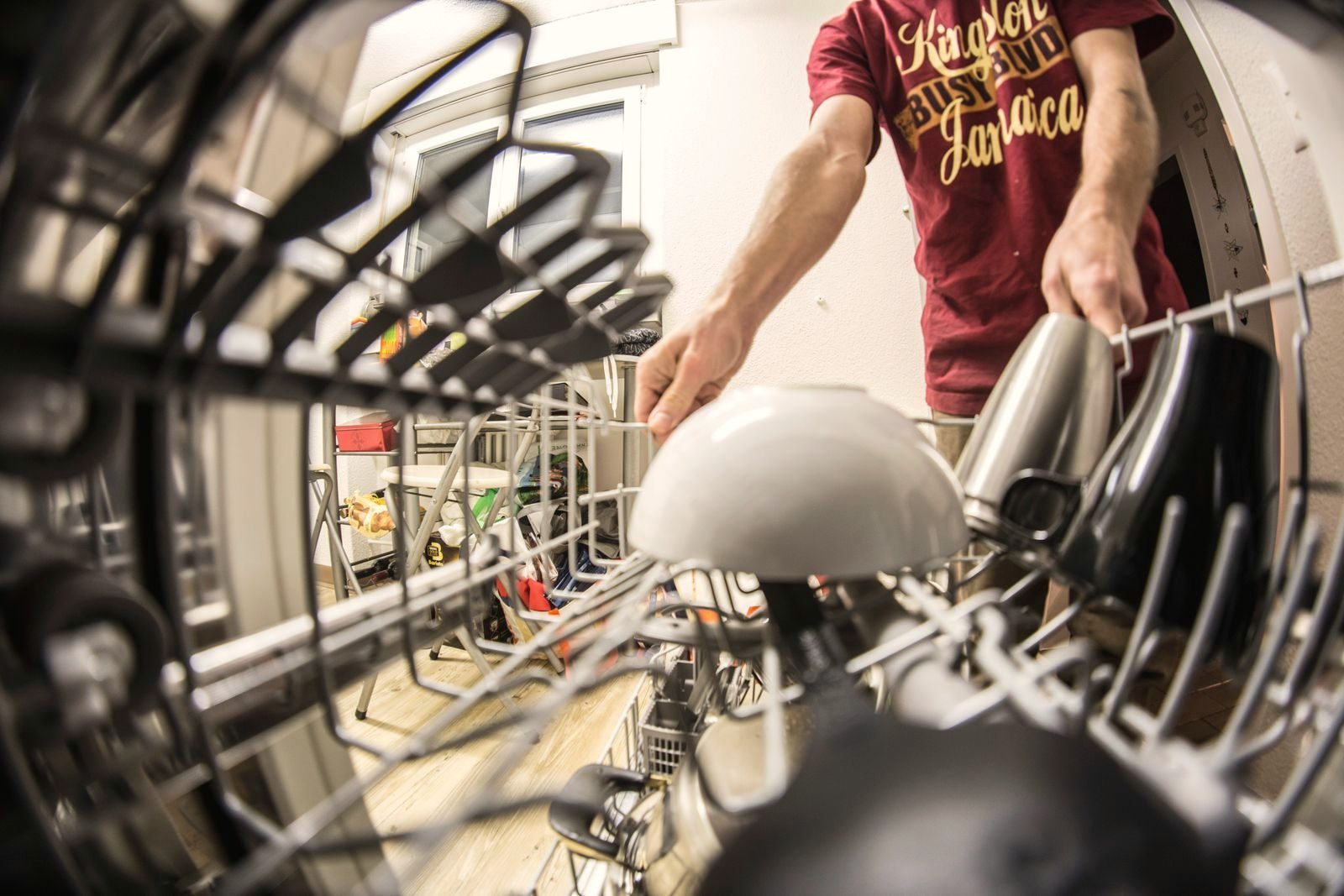 A loaded dishwasher rack pulled out for inspection