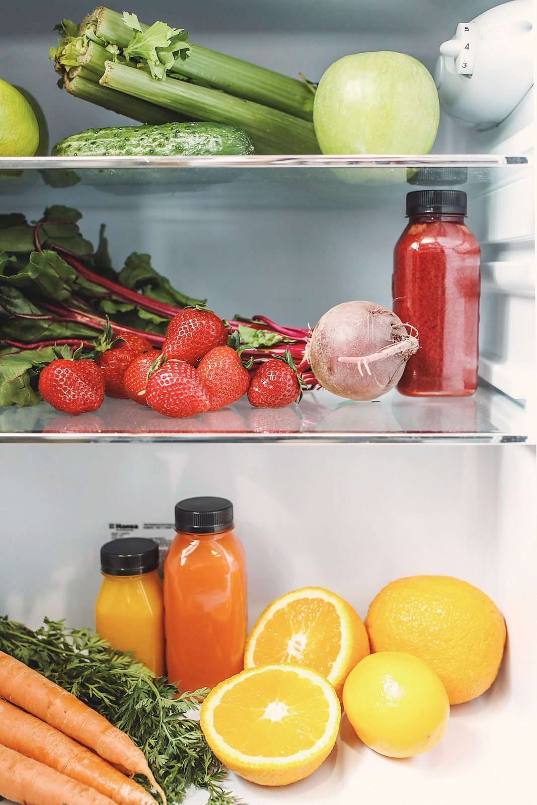 Fresh produce arranged on refrigerator shelves